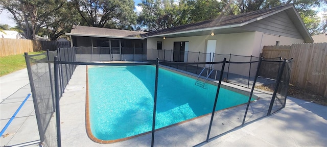 view of pool featuring a patio and a sunroom