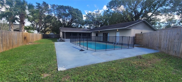 view of swimming pool featuring a patio area and a yard