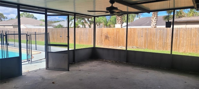 unfurnished sunroom with ceiling fan