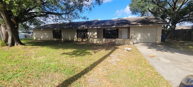 ranch-style house featuring a front lawn and a garage