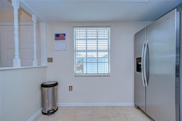 kitchen with light tile patterned flooring and stainless steel fridge with ice dispenser