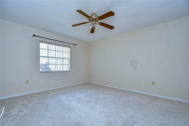 carpeted empty room with ceiling fan and a textured ceiling