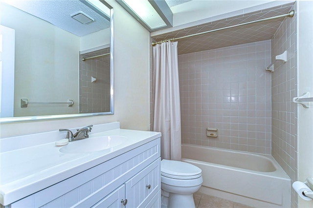 full bathroom with a textured ceiling, shower / bath combination with curtain, toilet, tile patterned floors, and vanity