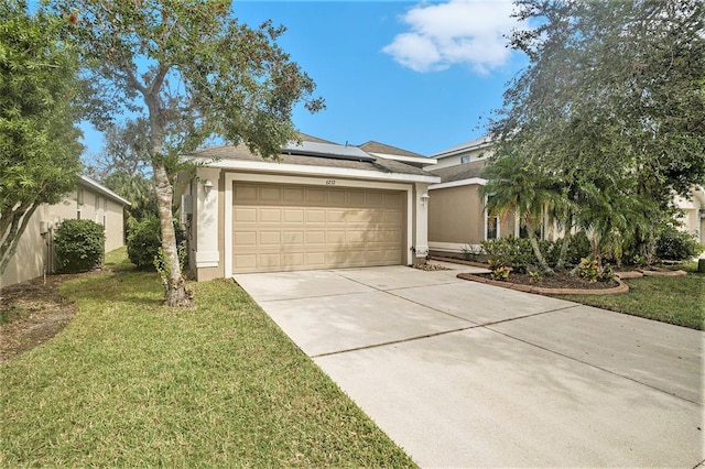 single story home with a garage and a front lawn