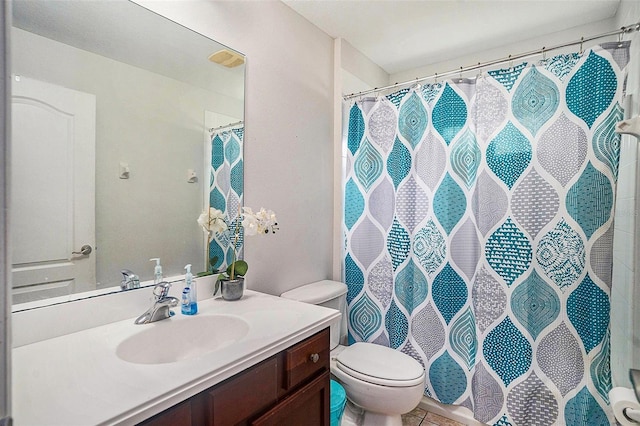 bathroom with vanity, walk in shower, tile patterned floors, and toilet