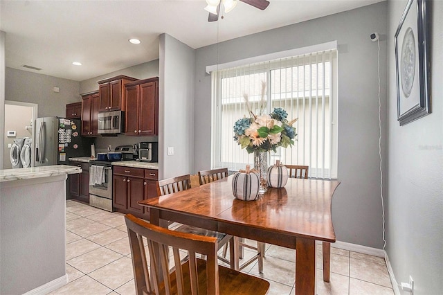 dining space featuring ceiling fan, light tile patterned floors, and independent washer and dryer