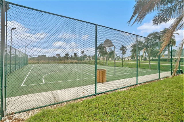 view of sport court with a yard