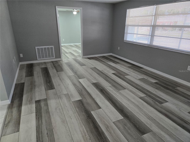 spare room featuring ceiling fan and light hardwood / wood-style flooring