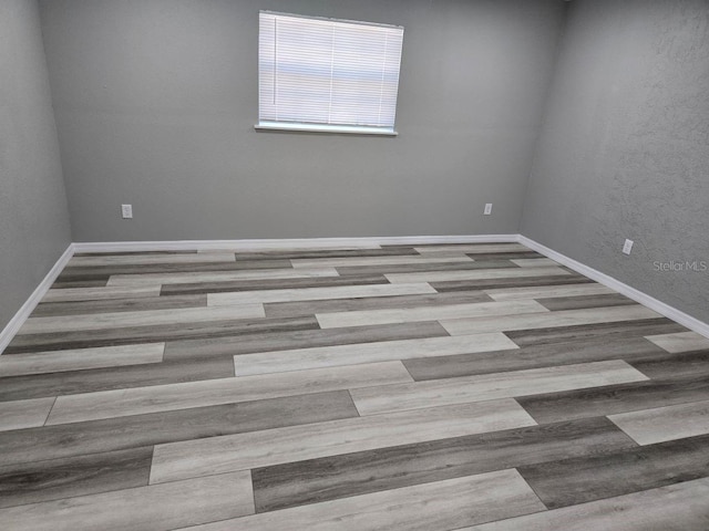 unfurnished room with light hardwood / wood-style flooring