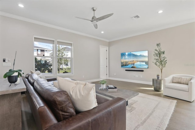 living room with ceiling fan, light hardwood / wood-style flooring, and crown molding