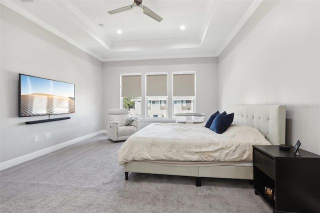 carpeted bedroom featuring a raised ceiling, ceiling fan, and crown molding