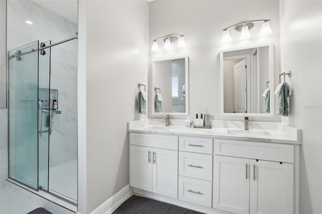 bathroom featuring a shower with shower door, vanity, and tile patterned flooring