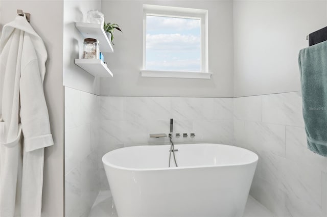 bathroom featuring a bathing tub and tile walls