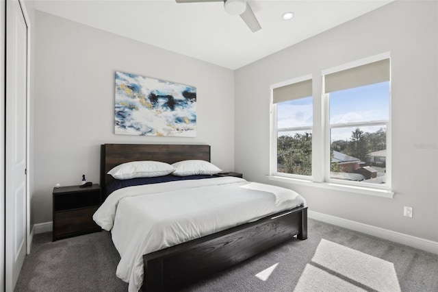 bedroom with ceiling fan, a closet, and dark carpet