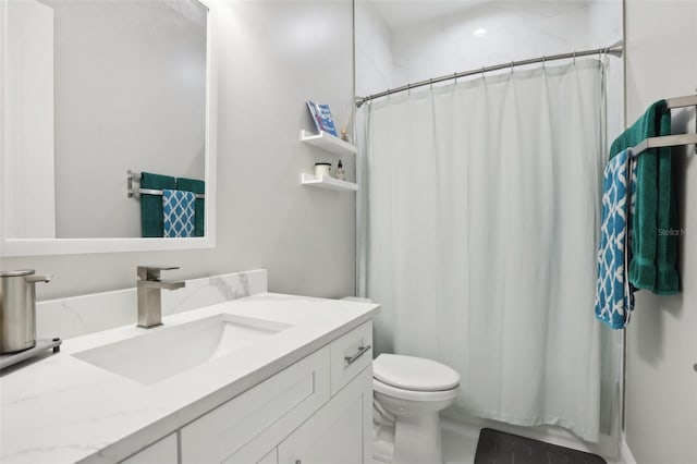 bathroom featuring walk in shower, vanity, and toilet