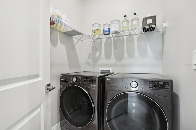 clothes washing area with washer and clothes dryer