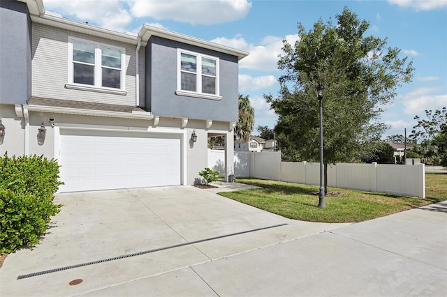 view of front of house featuring a garage and a front yard