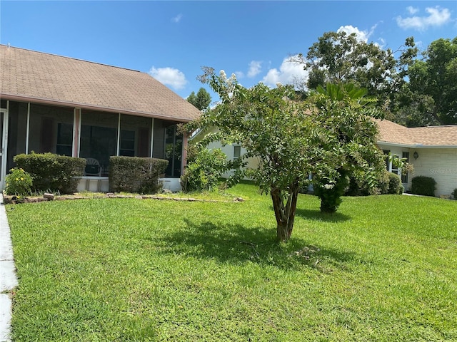 view of yard with a sunroom