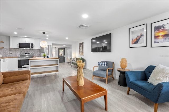 living room with light hardwood / wood-style flooring