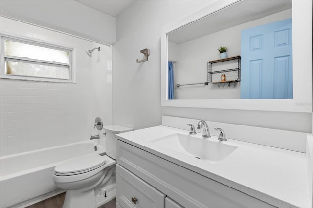 full bathroom with hardwood / wood-style floors, vanity, toilet, and tiled shower / bath combo