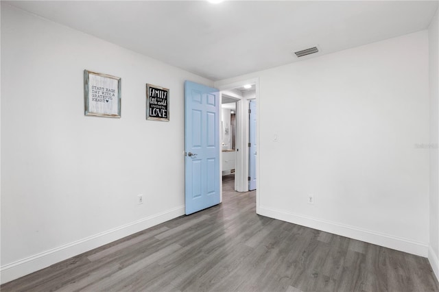 unfurnished room with wood-type flooring