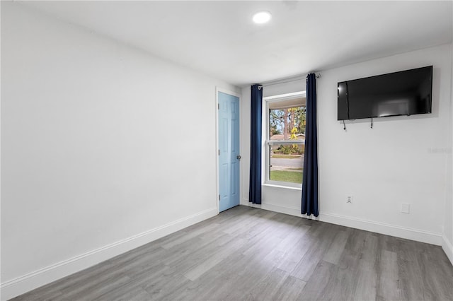 unfurnished room with light hardwood / wood-style flooring