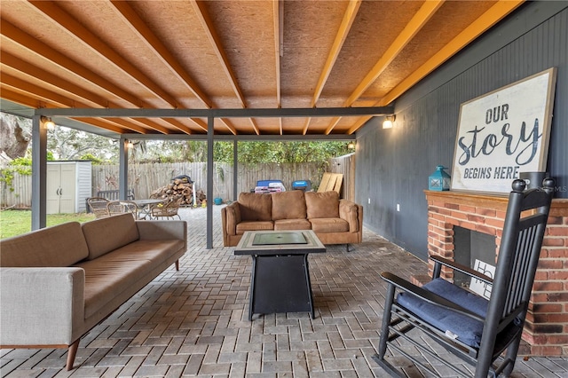 sunroom / solarium featuring an outdoor brick fireplace