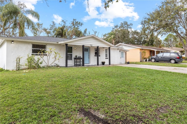 single story home featuring a front lawn