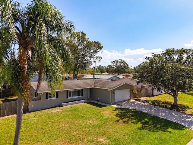 single story home with a garage and a front lawn