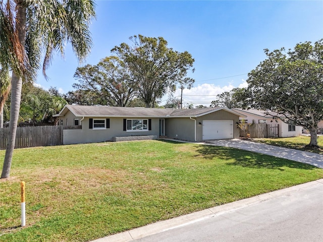 ranch-style house with a garage and a front lawn