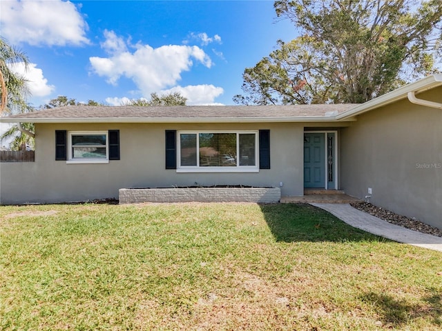 ranch-style house with a front lawn