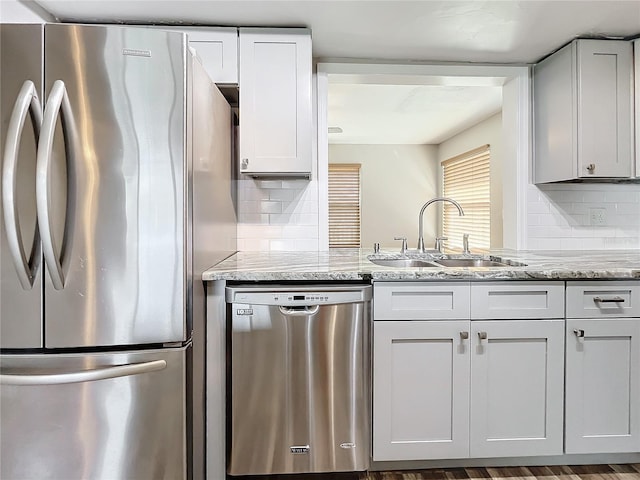 kitchen with white cabinetry, stainless steel appliances, and sink