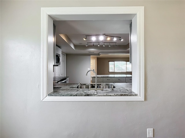 kitchen featuring sink, stainless steel appliances, and rail lighting