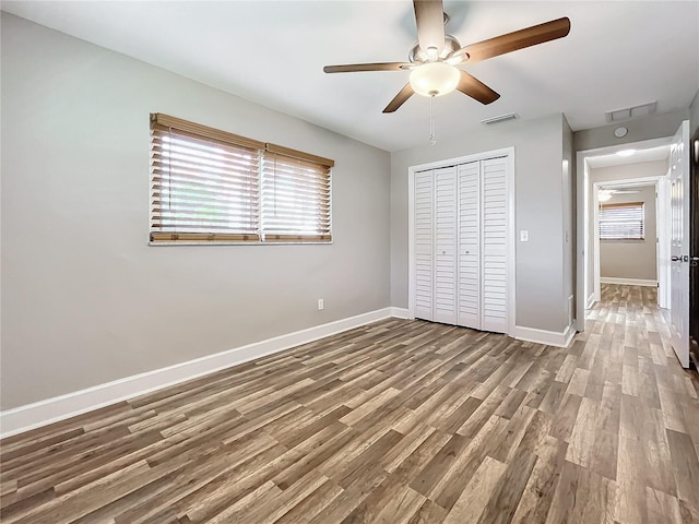 unfurnished bedroom featuring a closet, ceiling fan, and hardwood / wood-style flooring