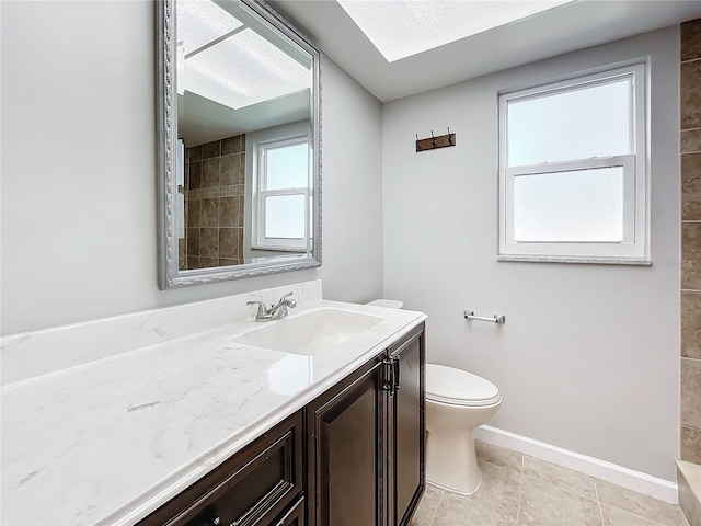 bathroom with vanity, toilet, and tile patterned flooring