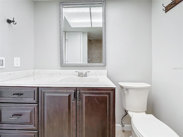 bathroom featuring toilet, vanity, and tile patterned floors