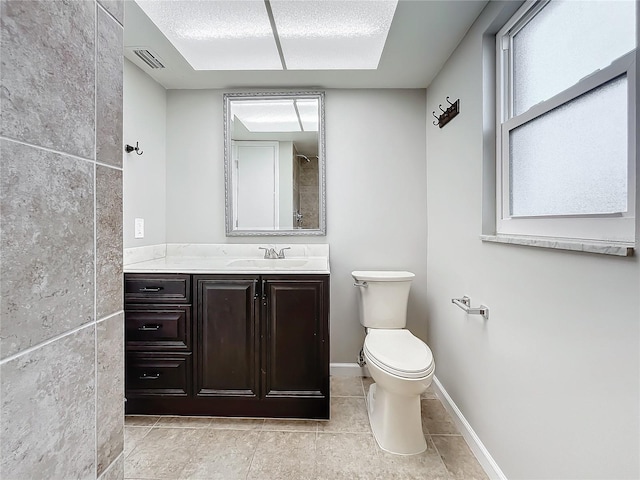 bathroom with vanity, toilet, and tile patterned flooring