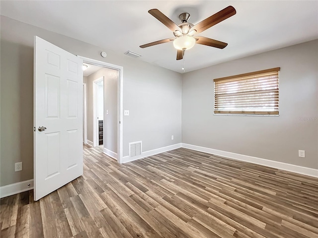 unfurnished room with ceiling fan and hardwood / wood-style floors