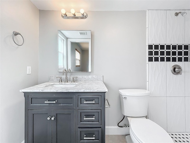 bathroom with toilet, walk in shower, vanity, and tile patterned flooring