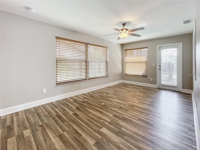 spare room featuring wood-type flooring and ceiling fan