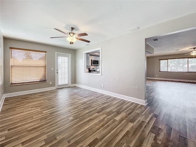 spare room with dark hardwood / wood-style floors and ceiling fan