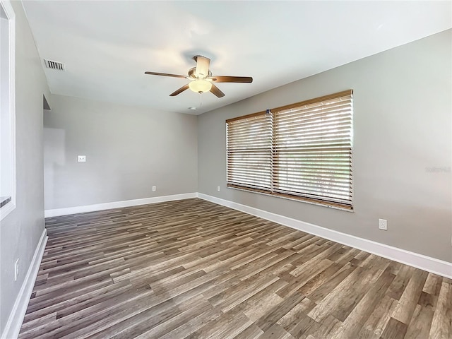 spare room featuring ceiling fan and dark hardwood / wood-style flooring