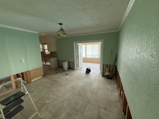 interior space featuring crown molding and a textured ceiling