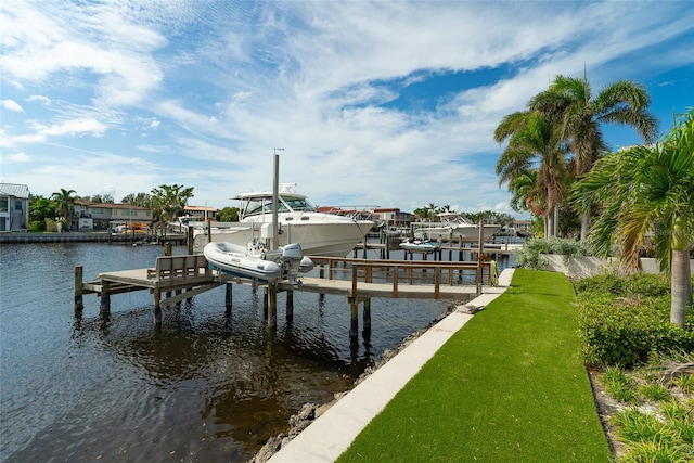 view of dock with a water view and a lawn