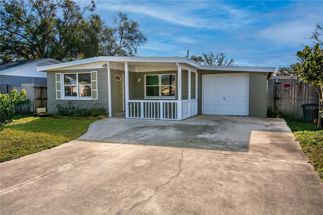 ranch-style house with a porch, a front yard, and a garage