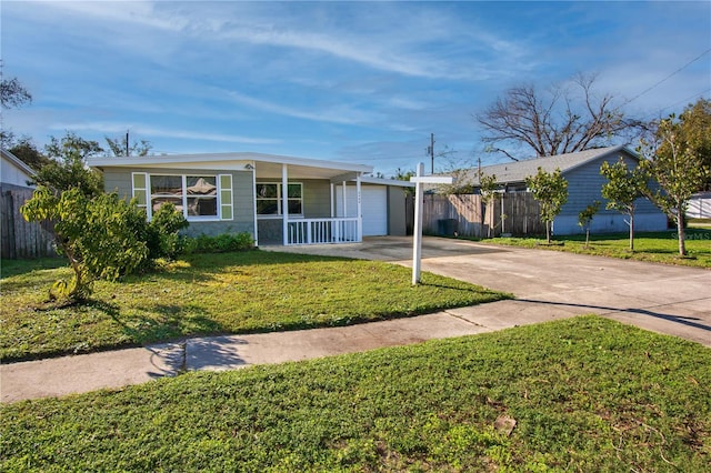 single story home featuring a porch, a front lawn, and a garage