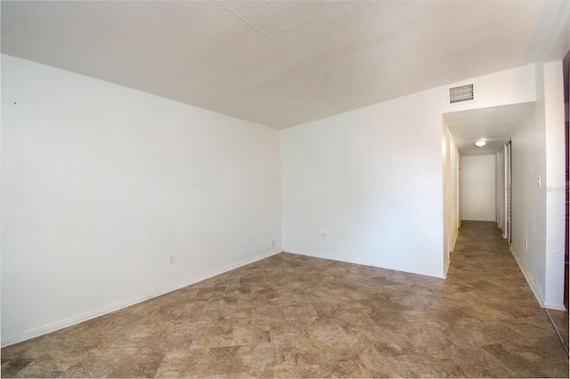 empty room with a textured ceiling