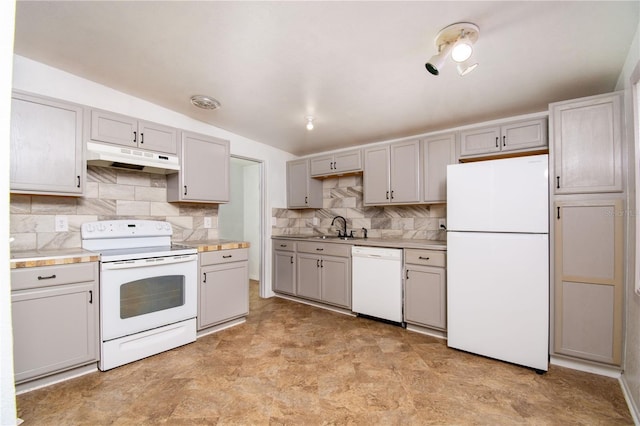 kitchen featuring sink, white appliances, gray cabinets, and decorative backsplash