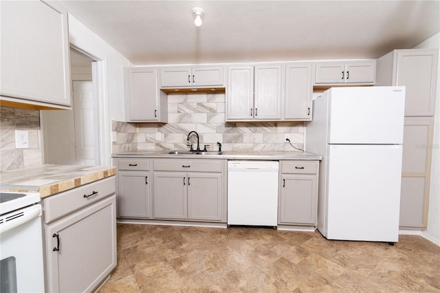 kitchen featuring tasteful backsplash, sink, white appliances, and white cabinets