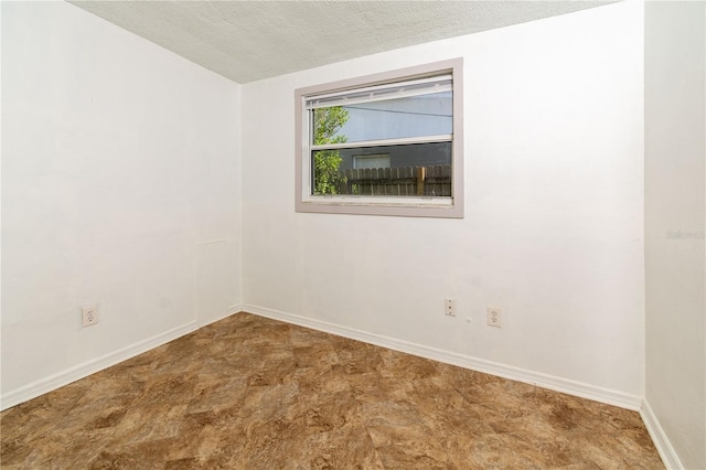 spare room with a textured ceiling